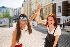 Two funny friends outdoors in the street photo