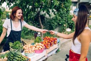 Seller woman offers fresh and organic vegetables farmers market. photo