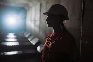 Silhouette of a female digger in the tunnel photo