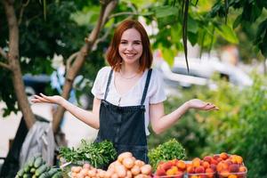 Woman seller at the counter with vegetables. Small business concept photo