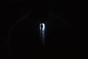Silhouette of a woman in a tunnel photo