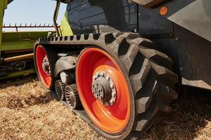 Large combine harvester parked in agriculturic field at summertime photo