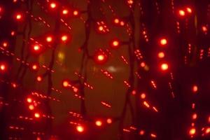 Red garlands in interior. Lights in dark. Room details. Light on window. photo