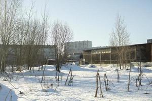 Industrial landscape in winter. View of city from wasteland. photo