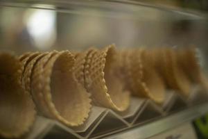 Waffle cones for ice cream. Sweets on the shop window. photo