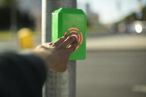 Pedestrian crossing alarm button. Button for road. Clicking on panel. photo