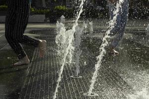 Fountain in city. City fountain on square. Spray of water. photo