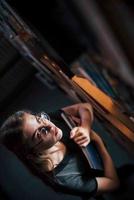 Aerial view. Female student is in library that full of books. Conception of education photo