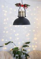 Christmas interior of a loft-style house with a black decorated retro lampshade and indoor plants of Strelitzia nicolai. New Year, comfort at home photo