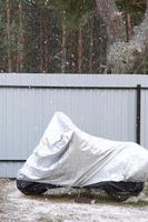 Motorcycle storage under an awning in winter outdoor. Protective awning, under the snow photo