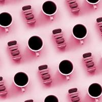 A pattern of many ful dessert cake macaroon and coffee cups on trendy background top view. Flat lay composition Image toned in Viva Magenta, color of the 2023 year photo