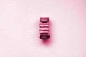 Dessert cake macaron or macaroon on trendy background top view. Flat lay composition Image toned in Viva Magenta, color of the 2023 year photo