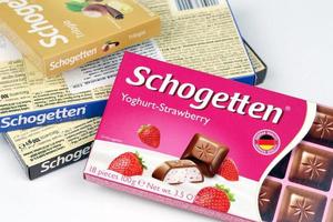 KHARKIV, UKRAINE - DECEMBER 18, 2022 Schogetten chocolate packs. Chocolate produced by Ludwig Schokolade GmbH and Co. KG, one of Europe's most successful confectionery suppliers photo