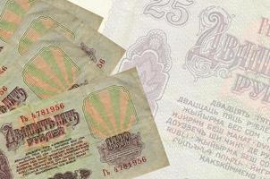 25 russian rubles bills lies in stack on background of big semi-transparent banknote. Abstract business background photo