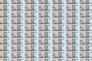 50 Thai Baht bills printed in money production conveyor. Collage of many bills. Concept of currency devaluation photo