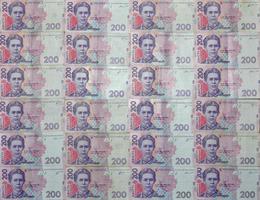 A close-up of a pattern of many Ukrainian currency banknotes with a par value of 200 hryvnia. Background image on business in Ukraine photo