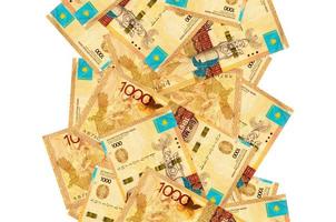 1000 Kazakhstani tenge bills flying down isolated on white. Many banknotes falling with white copyspace on left and right side photo