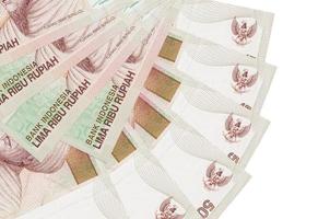 5000 Indonesian rupiah bills lies isolated on white background with copy space stacked in fan shape close up photo