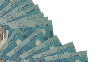 5 Canadian dollars bills lies isolated on white background with copy space stacked in fan close up photo