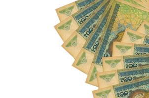 200 Uzbekistani som bills lies isolated on white background with copy space. Rich life conceptual background