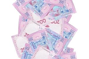 200 billetes de hryvnias ucranianos volando aislados en blanco. muchos billetes cayendo con copyspace blanco en el lado izquierdo y derecho foto