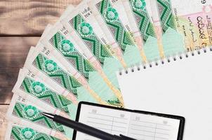 10 Sri Lankan rupees bills fan and notepad with contact book and black pen. Concept of financial planning and business strategy photo