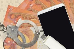 10 euro bills and smartphone with police handcuffs. Concept of hackers phishing attacks, illegal scam or malware soft distribution photo