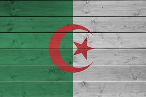 Algeria flag depicted in bright paint colors on old wooden wall. Textured banner on rough background photo