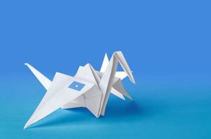 Somalia flag depicted on paper origami crane wing. Handmade arts concept photo