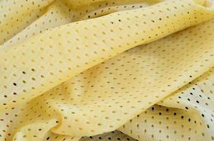 Yellow mesh sport wear fabric textile background pattern photo