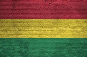Bolivia flag depicted in paint colors on old brick wall. Textured banner on big brick wall masonry background photo