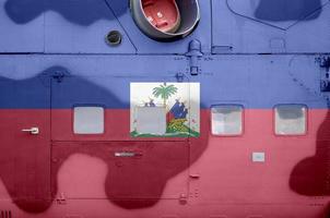 Haiti flag depicted on side part of military armored helicopter closeup. Army forces aircraft conceptual background photo