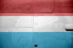 Luxembourg flag depicted on side part of military armored helicopter closeup. Army forces aircraft conceptual background photo