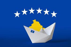 Kosovo flag depicted on paper origami ship closeup. Handmade arts concept photo