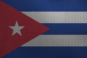 Cuba flag depicted in paint colors on old brushed metal plate or wall closeup. Textured banner on rough background photo