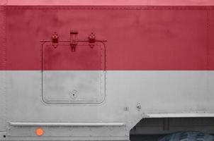 Indonesia flag depicted on side part of military armored truck closeup. Army forces conceptual background photo