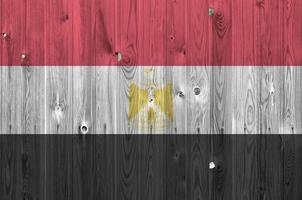 Egypt flag depicted in bright paint colors on old wooden wall. Textured banner on rough background photo