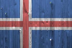 bandera de islandia representada en colores de pintura brillante en la pared de madera vieja. banner texturizado sobre fondo áspero foto