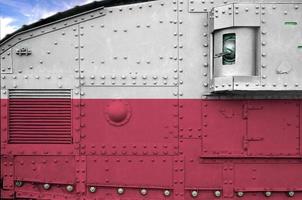 Poland flag depicted on side part of military armored tank closeup. Army forces conceptual background photo