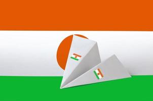 Niger flag depicted on paper origami airplane. Handmade arts concept photo