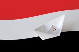 Yemen flag depicted on paper origami ship closeup. Handmade arts concept photo