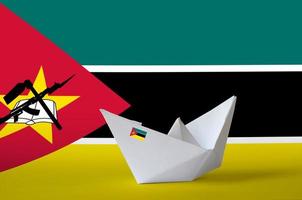 Mozambique flag depicted on paper origami ship closeup. Handmade arts concept photo