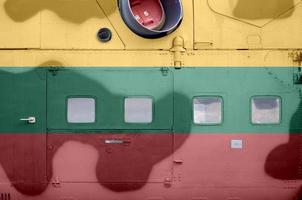 Lithuania flag depicted on side part of military armored helicopter closeup. Army forces aircraft conceptual background photo