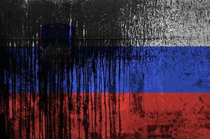 Slovenia flag depicted in paint colors on old and dirty oil barrel wall closeup. Textured banner on rough background photo