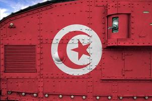 Tunisia flag depicted on side part of military armored tank closeup. Army forces conceptual background photo