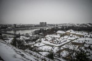 A panoramic view of Petrovaradin rooftops covered with snow photo