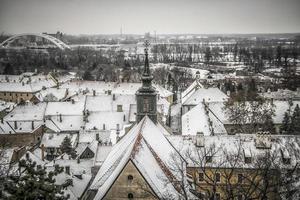 A panoramic view of Petrovaradin rooftops covered with snow photo