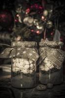 Two festive jars of hot chocolate with marshmallows photo