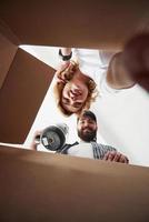 Time for unpacking. Happy couple together in their new house. Conception of moving photo