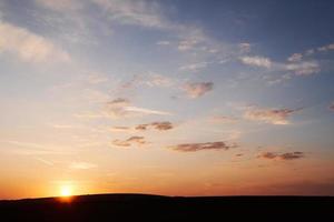 Sun goes down behind the horizon. Blue sky with clouds. In moravia photo